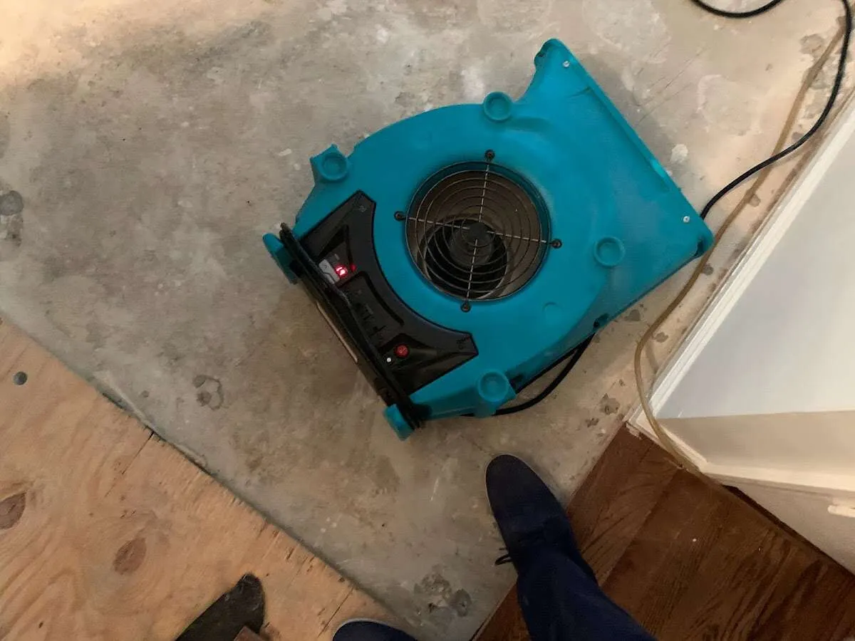 Air mover drying subfloor during Commercial Water Damage Restoration in Northchase